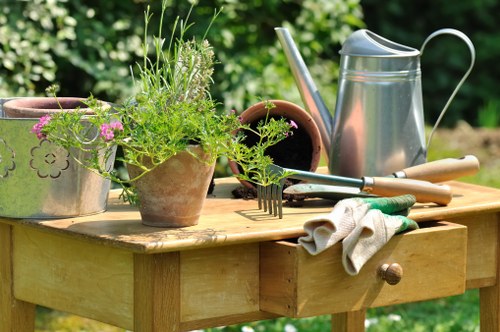 Professional gardeners using protective equipment on site